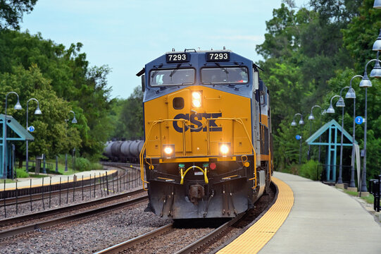 An ethanol train on Union Pacific Railroad tracks, led by CSX Transportation locomotives, passes through a Chicago suburgan commuter rail station with its flammable cargo.