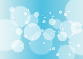 青色のグラデーションにキラキラしたボケが重なる背景