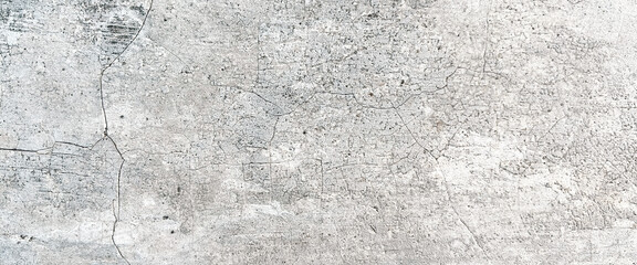 Close-up of a weathered concrete surface with cracks and a rough texture. Premium classic wall background photo for banner background or wallpaper.