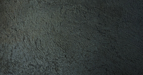 Close-up view of a rough, gray concrete wall, revealing its textured surface. Premium classic wall background photo for banner background or wallpaper.