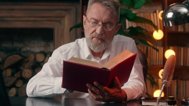 Old Caucasian man male pensioner elderly read book hobby leisure office successful home library reader turn page literary businessman business brainstorming bookshelf bookworm poetry textbook indoor
