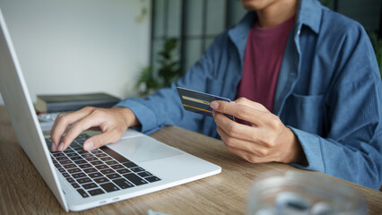 Businessman hold credit card online payment in laptop.