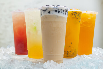 Taiwanese Boba milk tea and Passion fruit smoothies in plastic glass with ice on white background