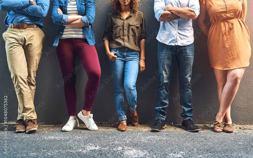 Poster we have some serious style. shot of a group unrecognizable people leaning against a wall while posin