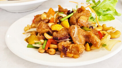 Cashew Chicken Delight: A mouthwatering close-up of a delectable cashew chicken stir-fry, showcasing a vibrant mix of tender chicken, crunchy cashews, colorful bell peppers, and a savory sauce.