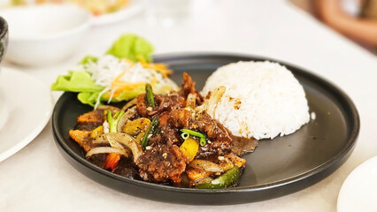 Black Pepper Crab with Rice: A mouthwatering black pepper Crab stir-fry is served with a generous portion of fluffy white rice, creating a delicious and satisfying meal.