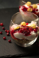 Two glasses of dessert with berries and nuts