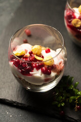 Two glasses of dessert with berries and nuts
