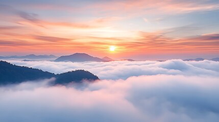 Obraz premium Breathtaking sunrise over mountain peaks shrouded in soft clouds a serene nature landscape scene