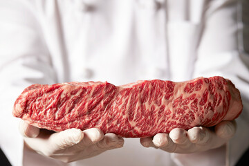 Fresh beef chunks in the chef's hand