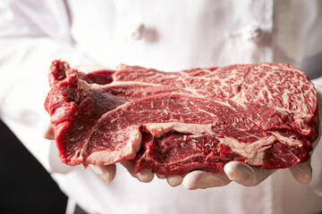 Fresh beef chunks in the chef's hand