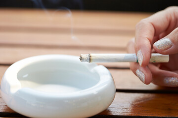 hand holding a cigarette