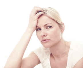 Fototapeta premium Woman, sad and thinking in studio for mental health, brain fog and depression. Person, trauma and stress on white background with anxiety, regret and doubt with difficult decision or life choice