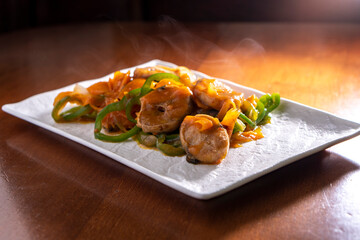 Fish with vegetables in sweet and sour sauce on white background. Food concept. Chinese food