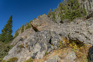 Obsidian Cliff, Yellowstone National Park , Wyoming.  Obsidian is a naturally occurring volcanic glass formed when lava extruded from a volcano cools rapidly with minimal crystal growth.  igneous rock