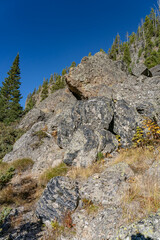 Obsidian Cliff, Yellowstone National Park , Wyoming.  Obsidian is a naturally occurring volcanic glass formed when lava extruded from a volcano cools rapidly with minimal crystal growth.  igneous rock