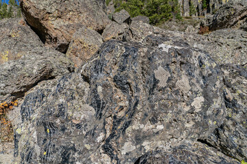 Obsidian Cliff, Yellowstone National Park , Wyoming.  Obsidian is a naturally occurring volcanic glass formed when lava extruded from a volcano cools rapidly with minimal crystal growth.  igneous rock