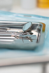 Dental tools arranged neatly on a tray in a modern clinic, ready for patient treatment and oral care procedures
