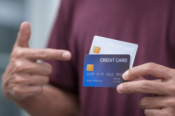 Close-up of a man's hand holding a bank credit card, highlighting online services for lending and access to credit,demonstrating financial convenience and flexibility for secure digital transactions