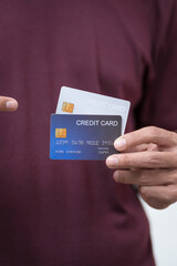 Close-up of a man's hand holding a bank credit card, highlighting online services for lending and...