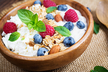 Cottage cheese for breakfast with granola, yogurt and fresh berries. Healthy breakfast.