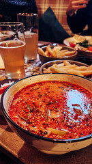 serving tom yum in a restaurant, family dinner
