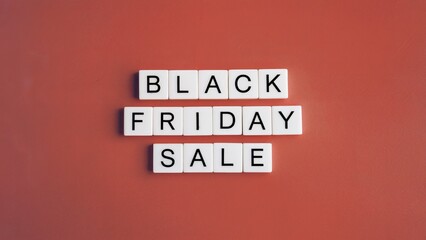 White square tiles with black lettering spelling out BLACK FRIDAY SALE against a red background.