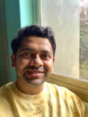 a happy Indian male smiling 