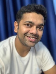 a happy Indian male smiling 
