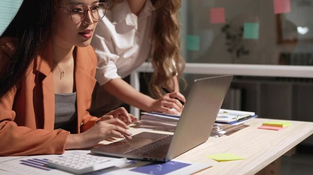 Team of professional business people working with laptops in the office Calculating operating results, summarizing work results, meeting, discussing, analyzing, and solving problems. Teamwork concept.