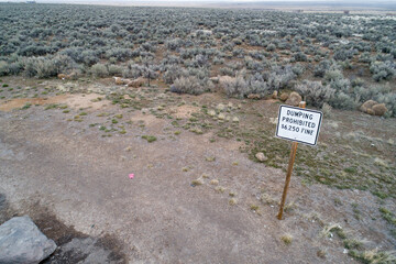 Remote Desert Landscape with Dumping Prohibited Sign