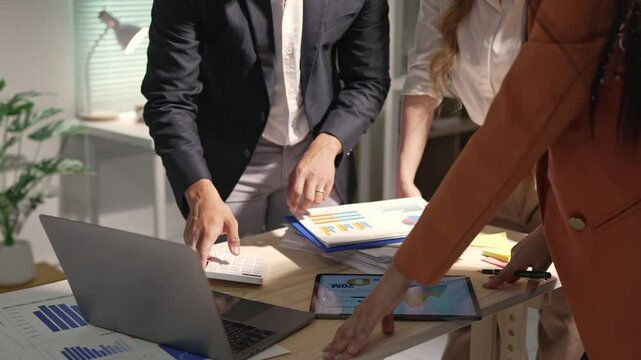 Team of professional business people working with laptops in the office Calculating operating results, summarizing work results, meeting, discussing, analyzing, and solving problems. Teamwork concept.