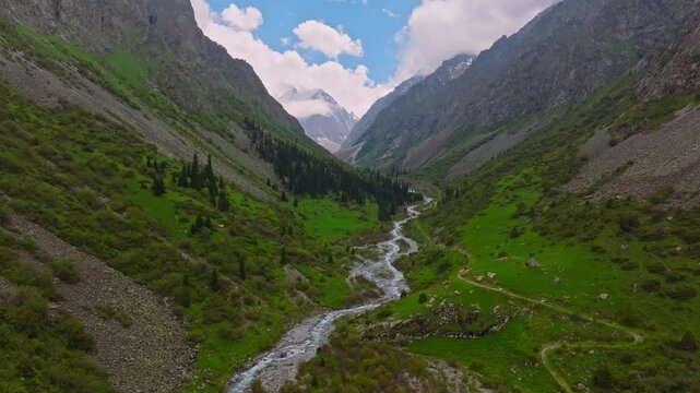 Ala Archa National Park at summer day in Kyrgyzstan, aerial view with pedestal up camera movement.
