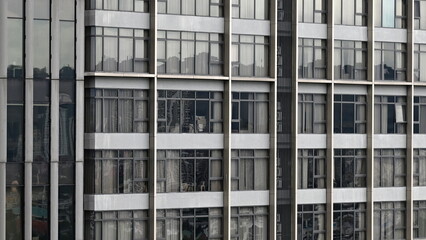Obraz premium Abstract architectural exterior detail of glass windows of a high rise tower building