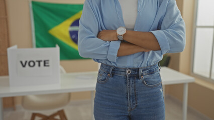 Young african american woman with arms crossed in an electoral college room with a brazilian flag...