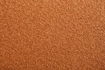 Close-up of coarse sandpaper texture in a rich brown hue, ideal for industrial and rough-themed backgrounds.