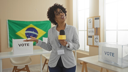 A beautiful african american woman presents in an electoral college room in brazil with voting materials and a brazilian flag in the background.