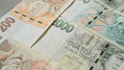 Various denominations of czech koruna banknotes arranged closely represent the currency of the czech republic vividly
