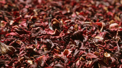 Closeup of dried hibiscus flowers showcasing their vibrant red and maroon hues.