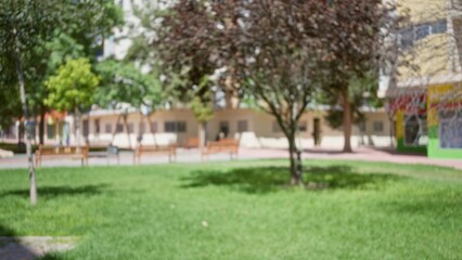 Defocused outdoor park scene with blurred background, green grass, and trees, evoking a tranquil atmosphere perfect for relaxation.