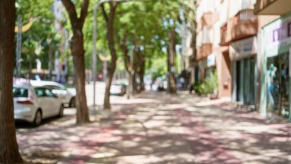 Defocused street view with blurred buildings and trees in a sunny outdoor urban area © Krakenimages.com