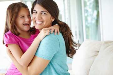 Funny, mom and embrace kid in home for love, care and family laughing together in living room. Happy girl, mother and hug child for support, connection and trust single parent with adopted daughter