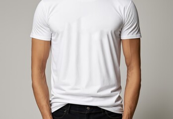 Obraz premium Blank t-shirt mockup worn by young fashionable man on white plain wall background for lettering and presentation of designer's works
