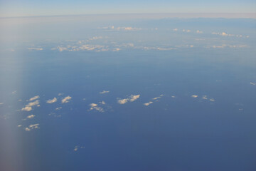 Blue sky view from an airplane window.