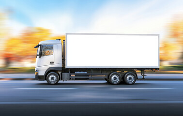 white delivery truck in motion on road, surrounded by autumn trees, conveying sense of speed and efficiency
