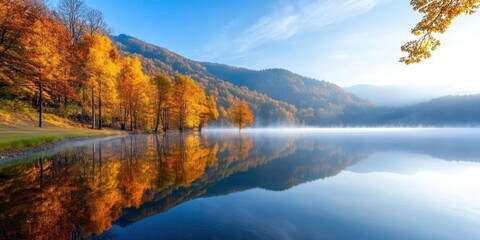Obraz premium A serene lake mirrors the golden autumn woods, mist drifting across the water in the gentle morning light, creating a tranquil Thanksgiving scene.