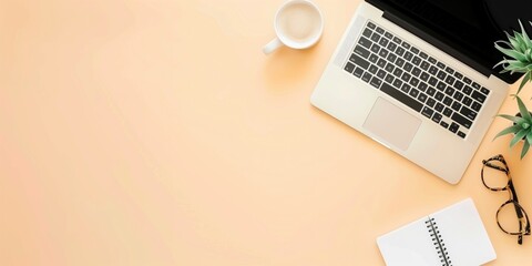 Top view banner with laptop, cup of coffee and office supplies on a beige background with space for text.