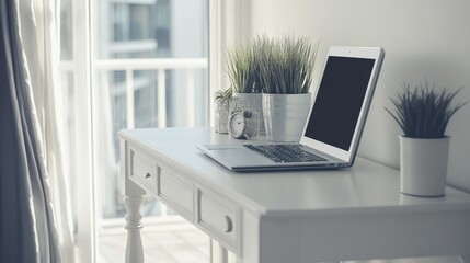 Fototapeta premium Modern White Desk with Laptop and Indoor Plants