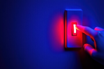 Hand pressing a glowing red light switch on a dark blue wall.