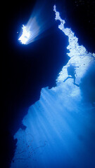 Underwater photo of a dreamlike and etheral environment. From a cave scuba dive in rays of sunlight.